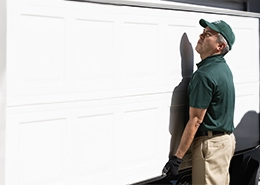 Man working on garage door.