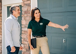 Worker explaining service to customer.