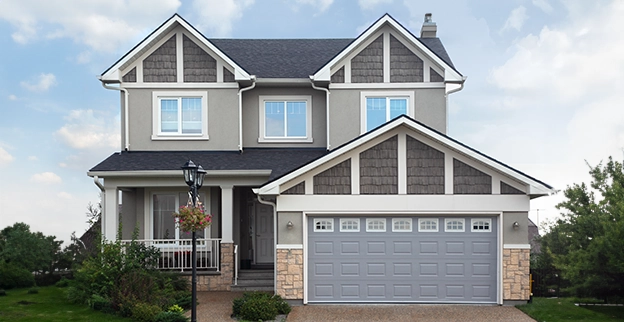 Gray house with white garage doors