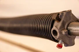 Close up side view of garage spring.