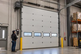 Precision Door expert inspecting sectional garage.