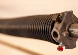 Close up side view of garage spring.