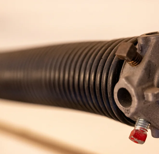 Close up side view of garage spring.