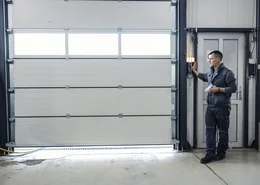 Precision Door professional inspecting sectional garage door.