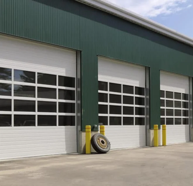 Three green and white sectional garage doors.