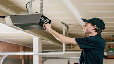 Man fixing a garage door opener