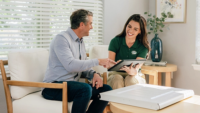 A PDS employee sitting with a client discussing options.