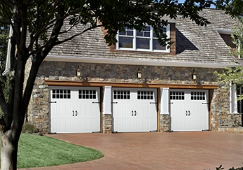A house with a triple garage door.