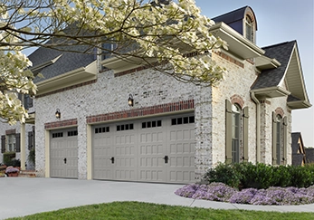 A house with a triple garage door.