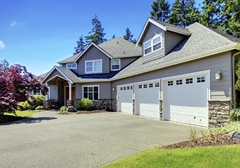 A house with a triple garage door.