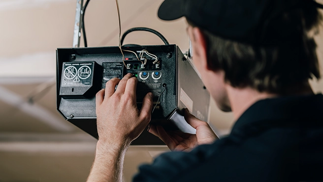 A PDS expert working on a garage door device.
