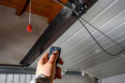 Hand programming a garage door opener remote.