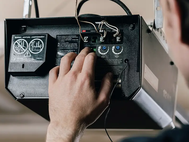 A qualified service professional installing one of the best garage door openers.