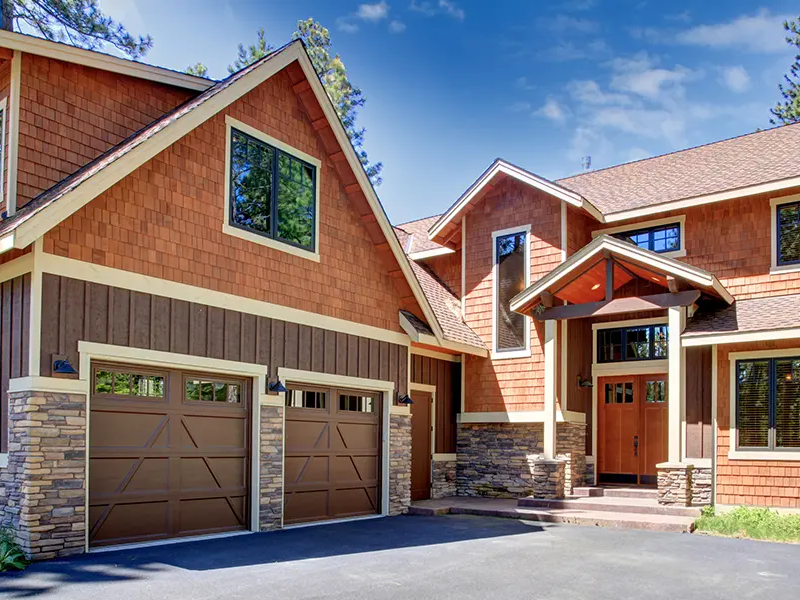 Brown garage doors installed by Precision Garage Door Service.