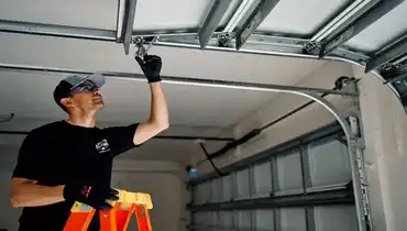 A Precision Garage Door service professional installing a low-headroom garage door in a residential garage.