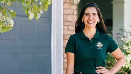 Precision Garage Door Service standing in front a fixed garage door.