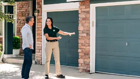 A Precision Garage Door Service professional installs a new door after a fire.