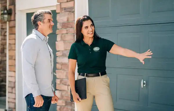 A Precision Garage Door service professional consulting a homeowner about steel garage doors.