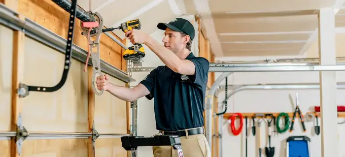 A Precision Garage Door Service professional completes a tune-up as part of a customer’s routine garage door maintenance.