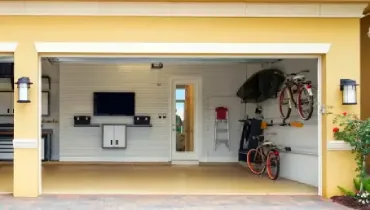 A remodeled garage with new fixtures in a yellow house.
