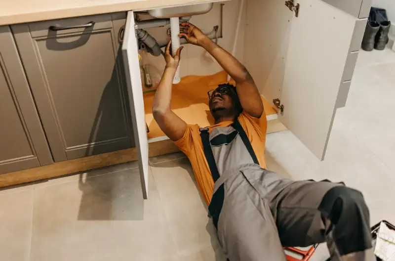 A service professional installing a sink in a newly remodeled garage. 