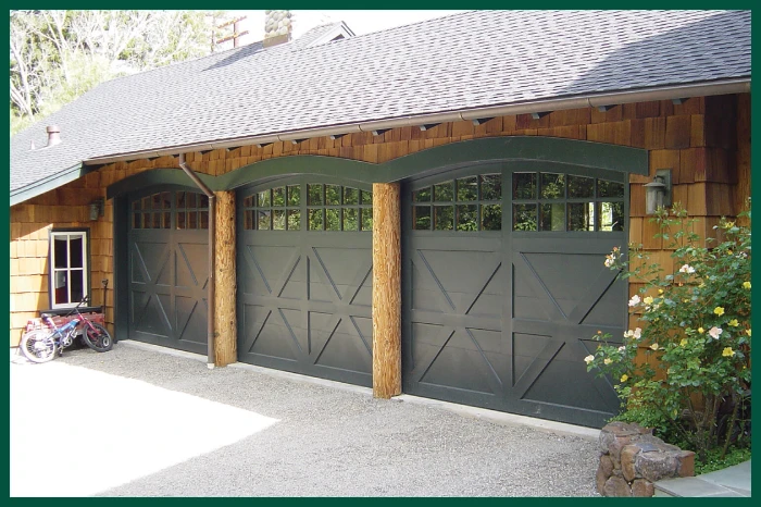 Small craftsman-style home with carriage garage doors.