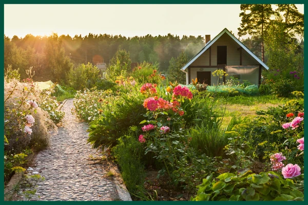 Small house with plant-lined walkway.