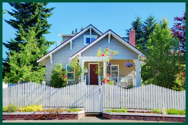 Cute house with wavy white fence.