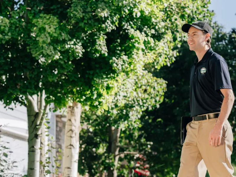 A Precision Garage Door Service professional walks up to a customer’s home.